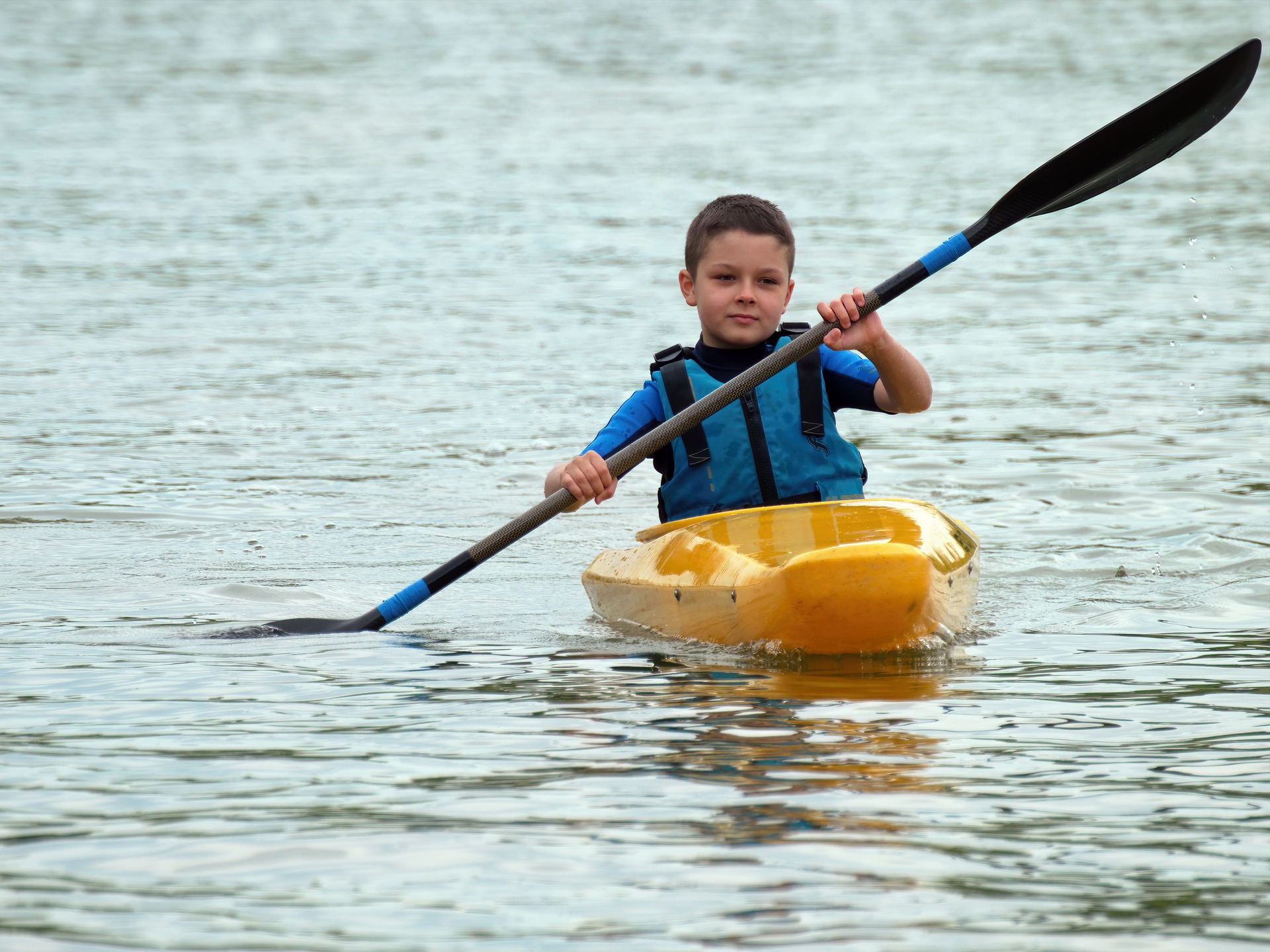 kayaking beginner child in yellow kayak