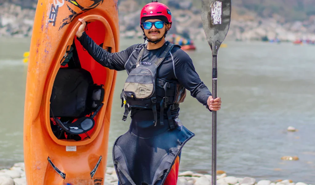 kayaker standing upright together with his kayak