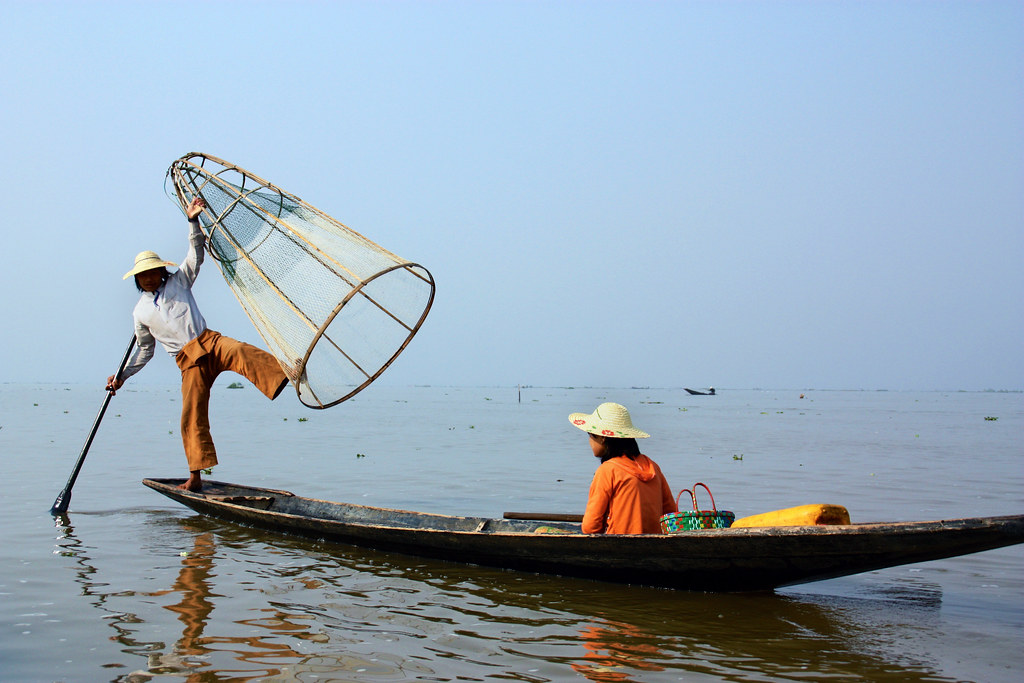 fisherman balancing on a kayak